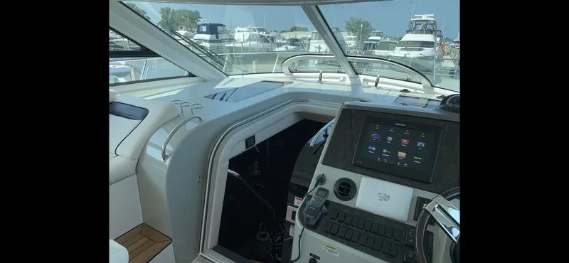 Slide: The Image of Interior view of 2010 Sea Ray 470 Sundancer with modern helm console. - 12