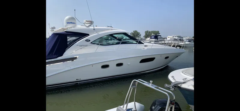 Slide: The Image of 2010 Sea Ray 470 Sundancer docked, side view. - 2