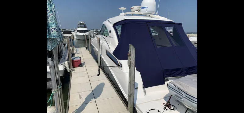 Slide: The Image of 2010 Sea Ray 470 Sundancer docked with blue cover. - 5