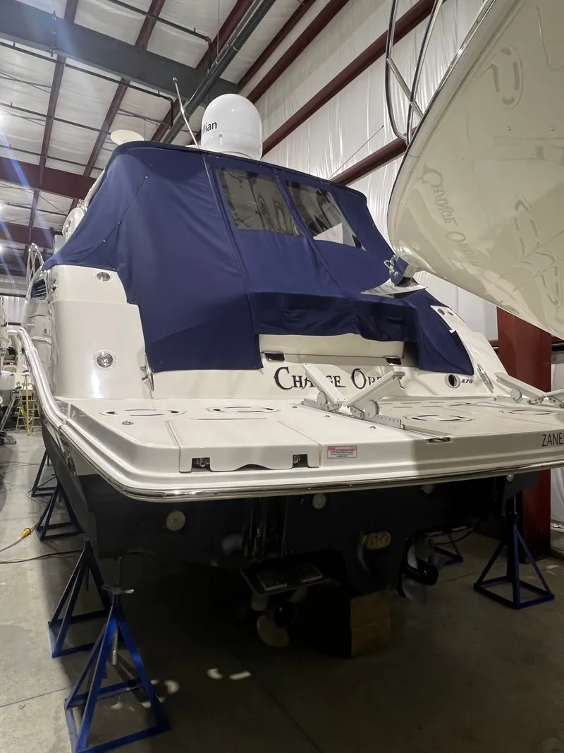 Slide: The Image of 2010 Sea Ray 470 Sundancer yacht stored on stands indoors. - 7