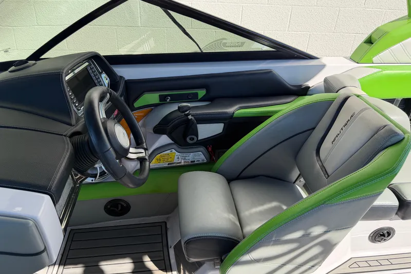 Slide: The Image of 2014 Nautique Super Air Nautique G23 boat interior with green and gray seating. - 10