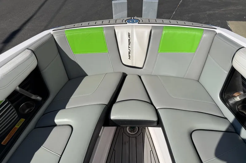 Slide: The Image of 2014 Nautique Super Air Nautique G23 boat interior with gray and green seating. - 15