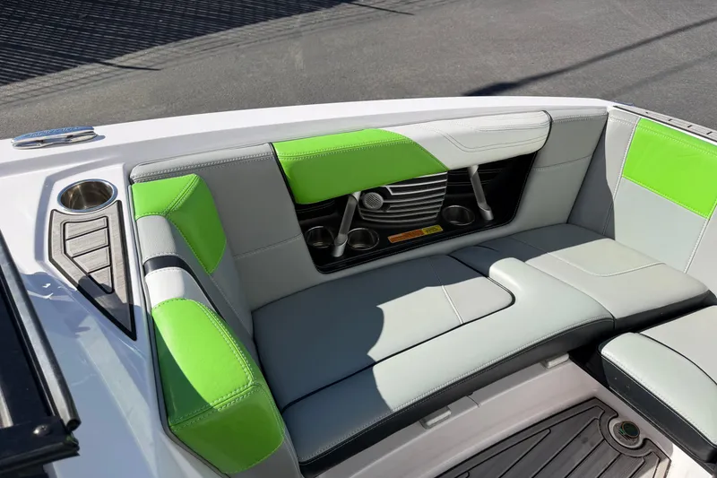 Slide: The Image of 2014 Nautique Super Air Nautique G23 interior with green and gray seating. - 16