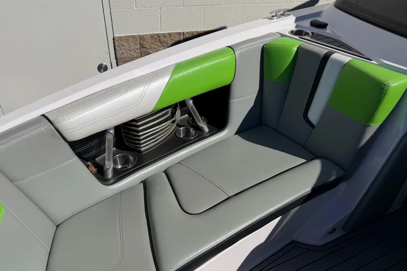Slide: The Image of 2014 Nautique Super Air Nautique G23 interior with green and gray seating, cup holders. - 17