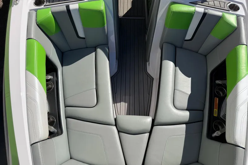 Slide: The Image of 2014 Nautique Super Air Nautique G23 interior with gray and green seating. - 18