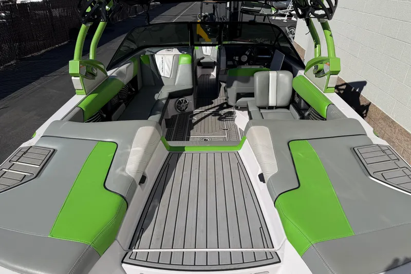 Slide: The Image of 2014 Nautique Super Air Nautique G23 interior with green and gray seating. - 3