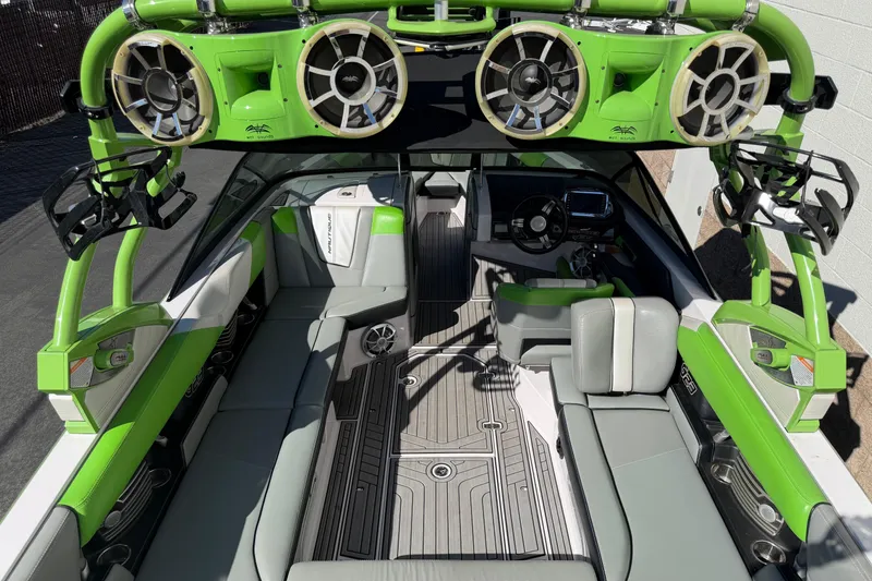 Slide: The Image of 2014 Nautique Super Air Nautique G23 interior with green accents and advanced sound system. - 4