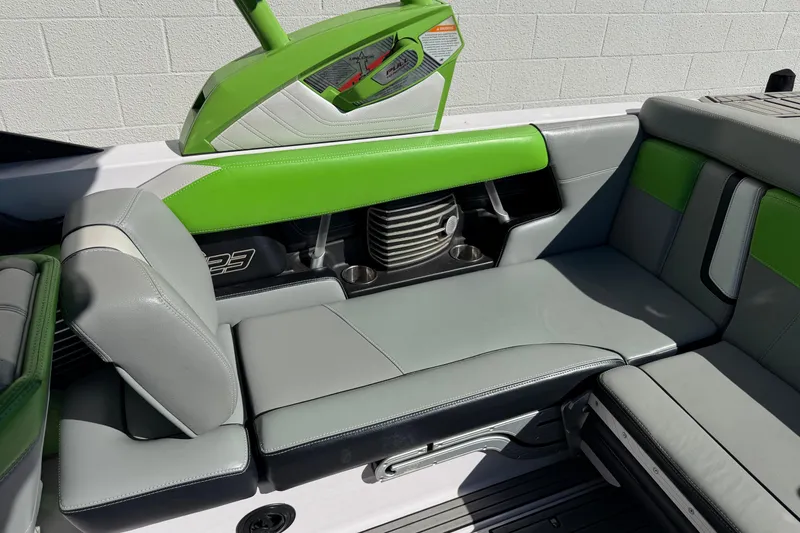 Slide: The Image of 2014 Nautique Super Air Nautique G23 interior with green and gray seating. - 6