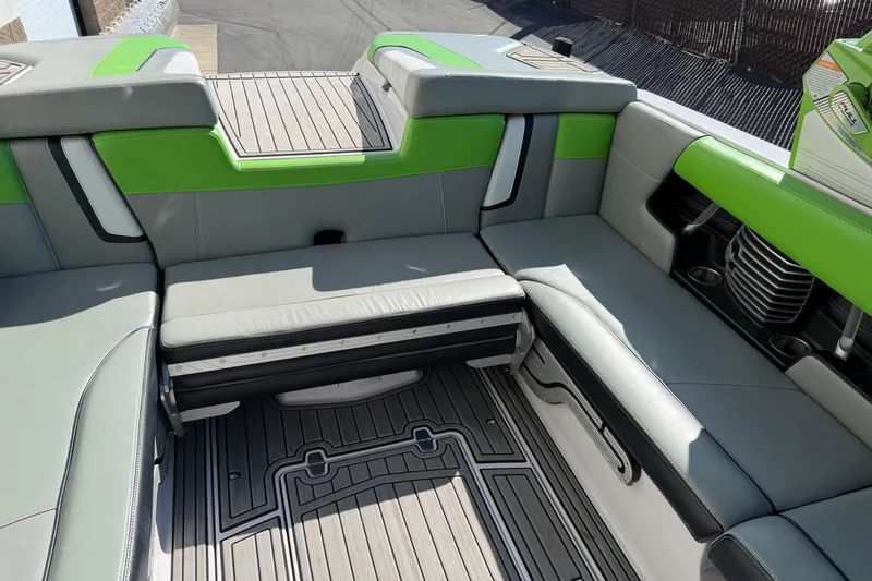 Slide: The Image of 2014 Nautique Super Air Nautique G23 interior with green and gray seating. - 7