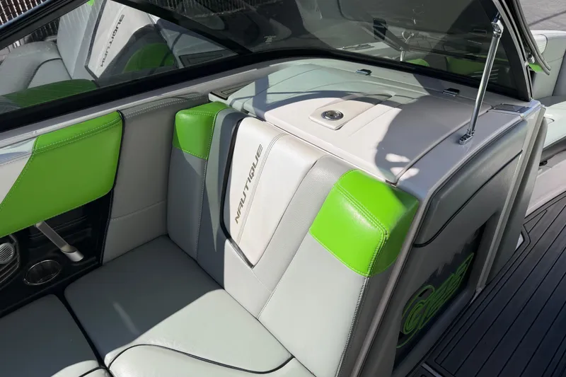 Slide: The Image of 2014 Nautique Super Air Nautique G23 interior with green and gray seating. - 9