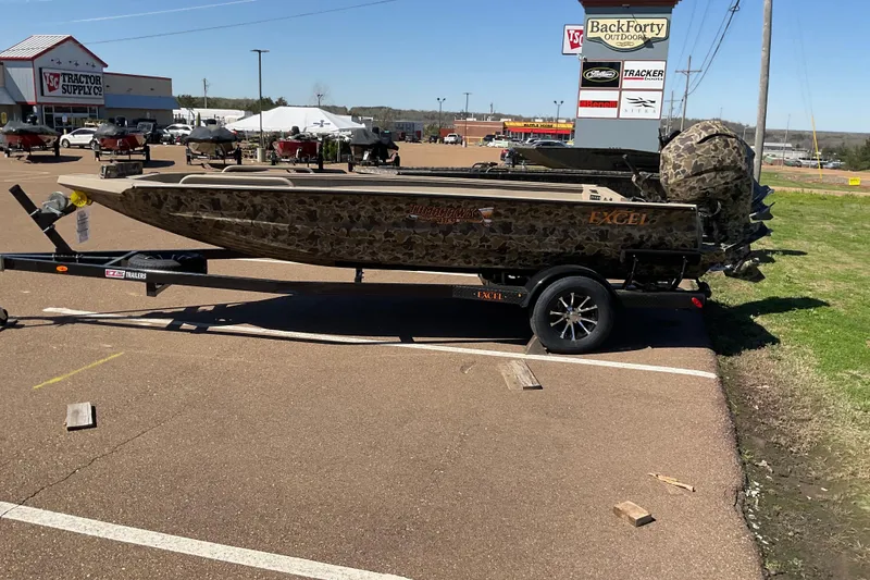 The Image of 2026 Excel 183 Tomahawk boat on trailer at outdoor dealership. - 0