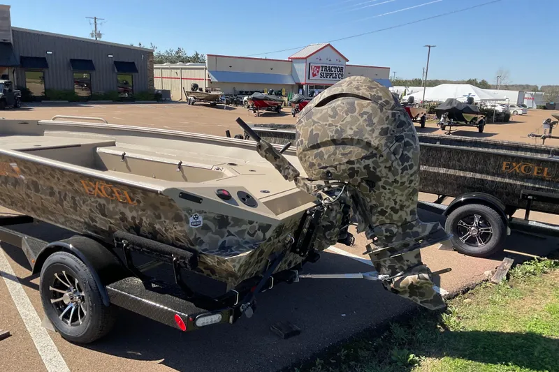 Slide: The Image of Camouflage Excel 183 Tomahawk boat on trailer, parked outside Tractor Supply Co. - 2