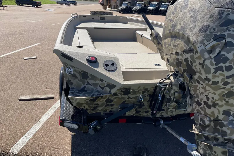 Slide: The Image of Camouflage-patterned 2026 Excel 183 Tomahawk boat on trailer in parking lot. - 4