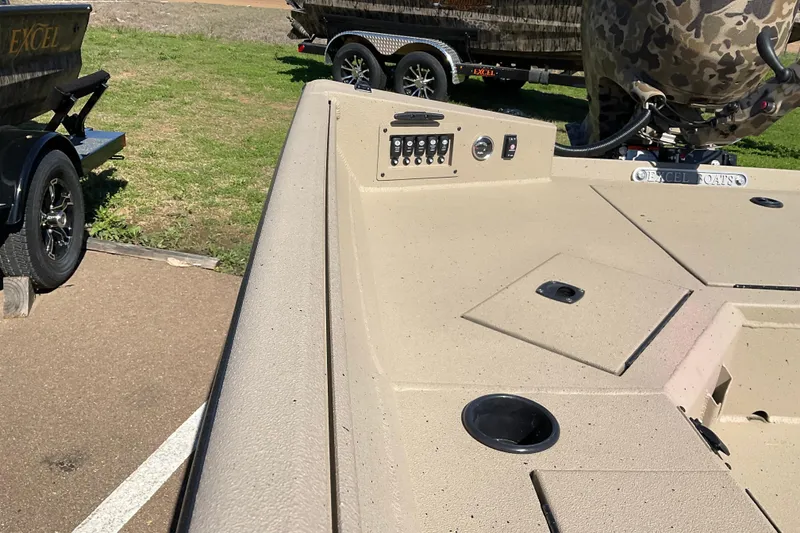 Slide: The Image of 2026 Excel 183 Tomahawk boat deck with control panel and storage compartments. - 5