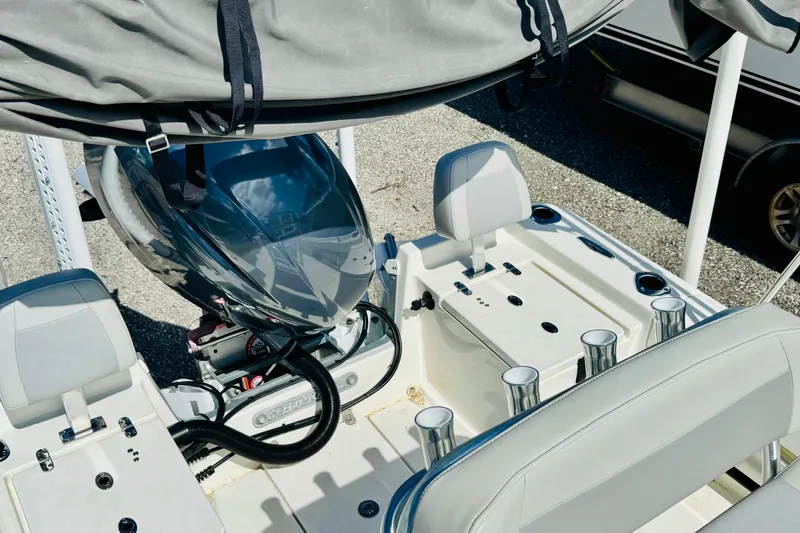 Slide: The Image of 2023 KenCraft 219 Bay Rider boat interior with engine and seating. - 10