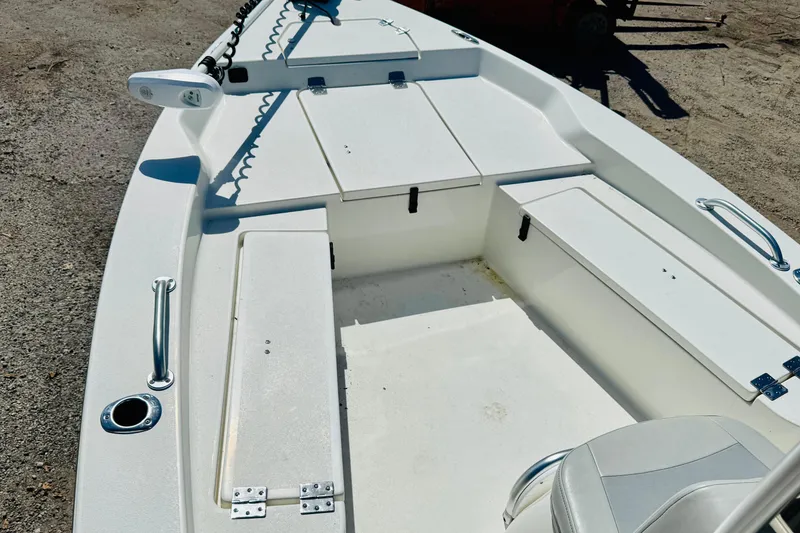 Slide: The Image of 2023 KenCraft 219 Bay Rider boat interior with storage compartments and seating. - 13