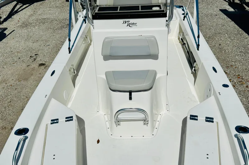 Slide: The Image of 2023 KenCraft 219 Bay Rider boat interior with seating and storage compartments. - 14