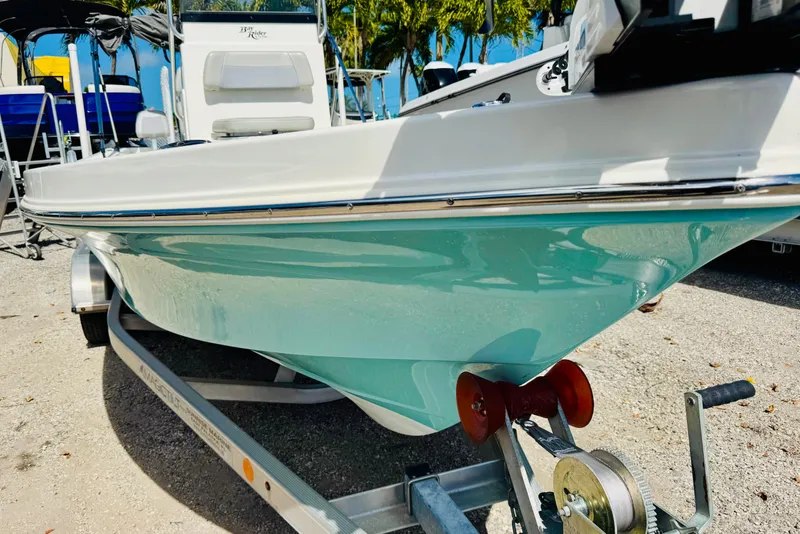 Slide: The Image of 2023 KenCraft 219 Bay Rider boat on trailer, turquoise hull, outdoor display. - 6