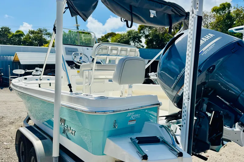 Slide: The Image of 2023 KenCraft 219 Bay Rider boat with Yamaha engine, parked on a trailer. - 8