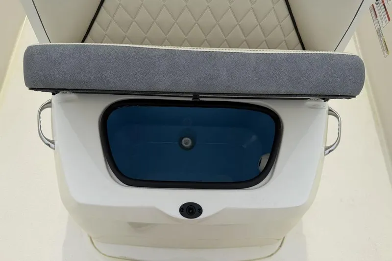 Slide: The Image of 2023 Stingray 173 CC boat seat with storage compartment, featuring a cushioned top. - 14