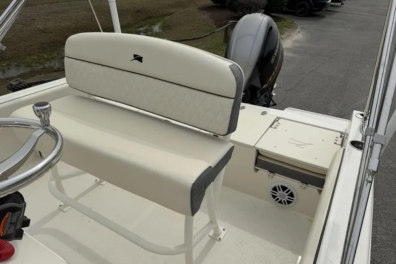 Slide: The Image of 2023 Stingray 173 CC boat interior with steering wheel and cushioned seating. - 9