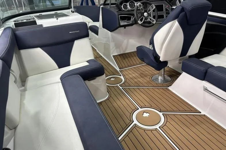 Slide: The Image of 2019 MasterCraft XT22 boat interior with luxurious seating and stylish dashboard. - 10
