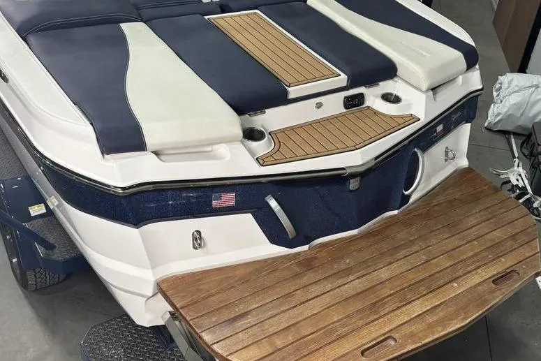 Slide: The Image of 2019 MasterCraft XT22 boat with teak swim platform and cushioned seating. - 11