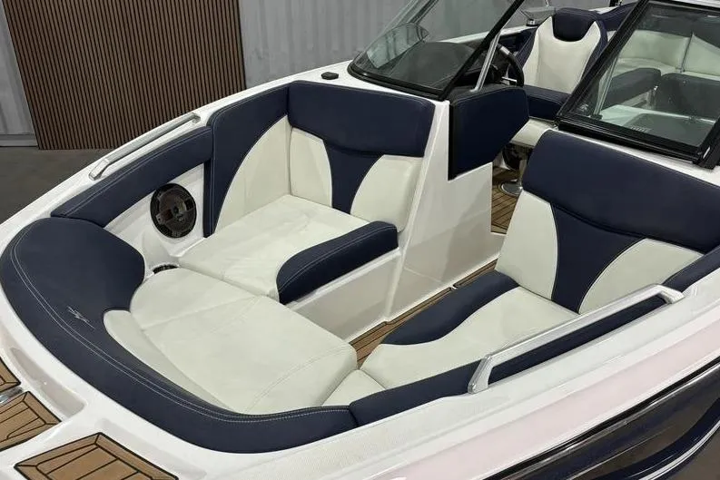 Slide: The Image of 2019 MasterCraft XT22 boat interior with navy and white seating, showcasing luxury design. - 4