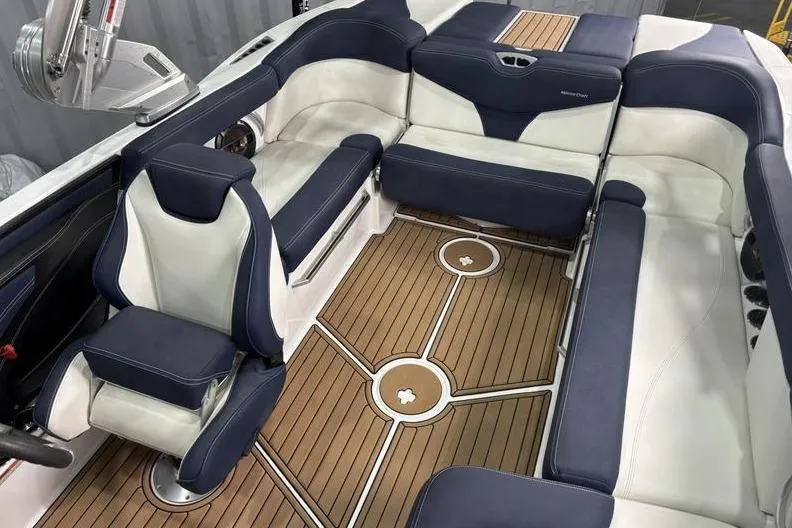 Slide: The Image of 2019 MasterCraft XT22 boat interior with blue and white seating, teak-style flooring. - 5