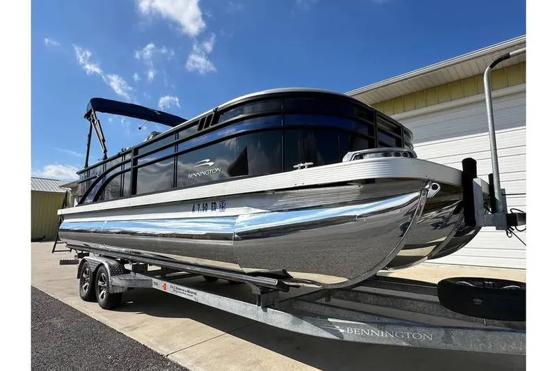 The Image of 2022 Bennington 24 SXSR Tritoon with Yamaha Vmax 250 SHO on trailer, sunny day. - 1