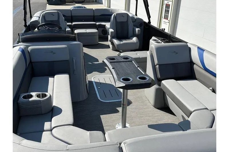 Slide: The Image of 2022 Bennington 24 SXSR Tritoon interior with seating, table, and cup holders. - 15