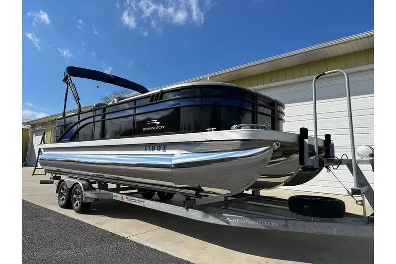Slide: The Image of 2022 Bennington 24 SXSR Tritoon with Yamaha Vmax 250 SHO on trailer, sunny day. - 6