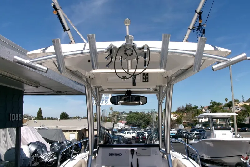 Slide: The Image of 2018 Sea Fox 248 Commander boat with fishing rod holders and electronics, docked at marina. - 21