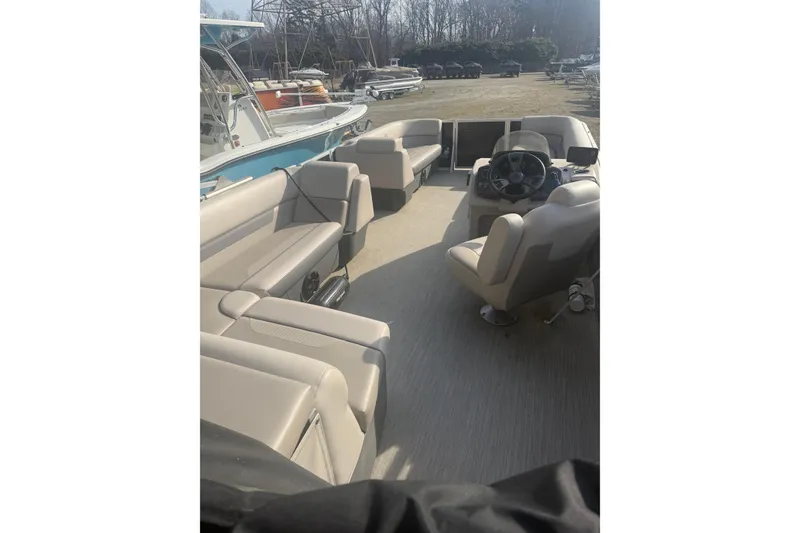 Slide: The Image of 2020 Princecraft Vectra 23 pontoon boat interior with beige seating and steering console. - 15