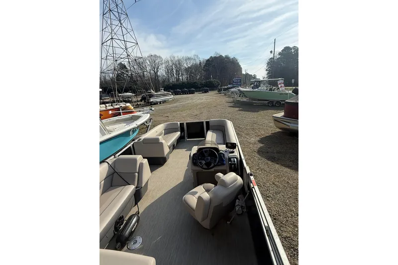 Slide: The Image of 2020 Princecraft Vectra 23 pontoon boat with beige seating, parked outdoors. - 17