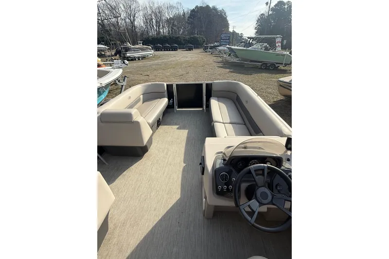Slide: The Image of 2020 Princecraft Vectra 23 pontoon boat interior with beige seating and steering console. - 18