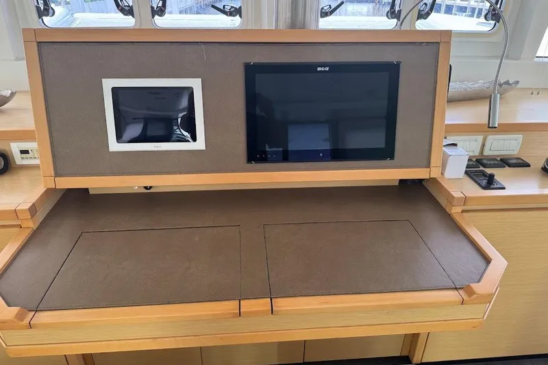 Slide: The Image of 2015 Lagoon yacht interior with navigation screens and control panel. - 16