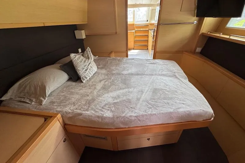 Slide: The Image of Luxurious bedroom interior of a 2015 Lagoon yacht with cozy bedding and modern design. - 17