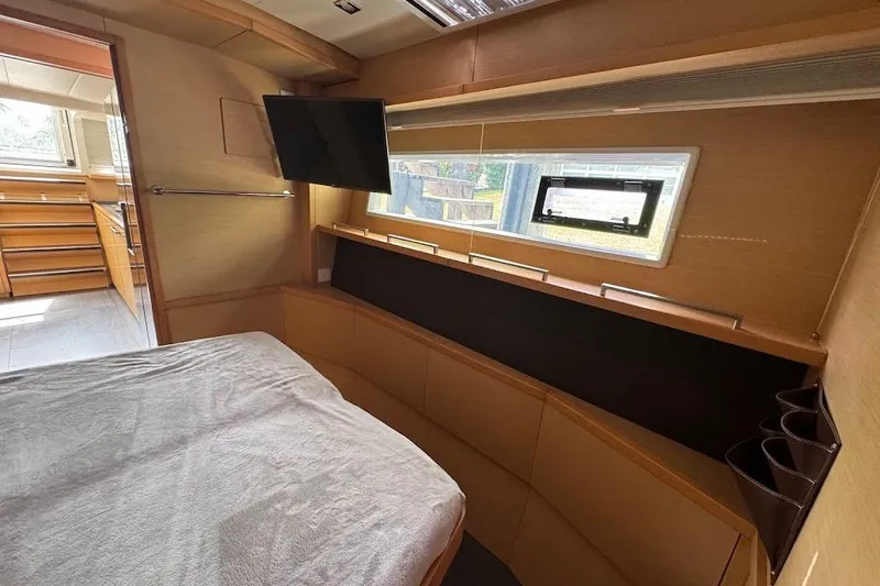 Slide: The Image of Luxurious 2015 Lagoon yacht interior with bed, TV, and window view. - 18