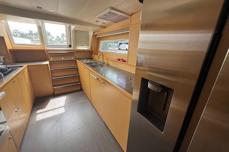 Slide: The Image of Modern kitchen interior on a 2015 Lagoon yacht, featuring stainless steel appliances and ample natural light. - 20