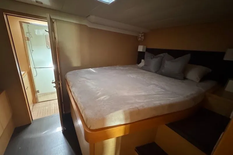 Slide: The Image of Luxurious 2015 Lagoon yacht bedroom with cozy bed and adjacent bathroom. - 22