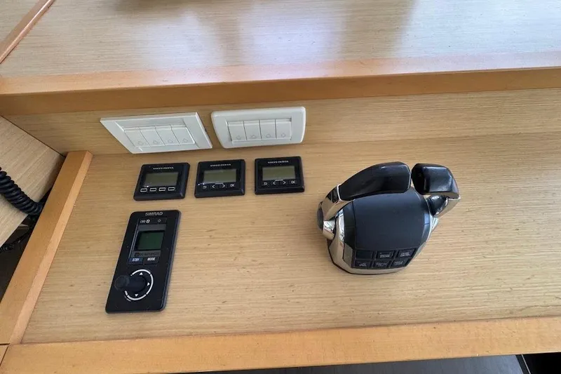 Slide: The Image of Control panel of a 2015 Lagoon boat with switches and throttle levers. - 24