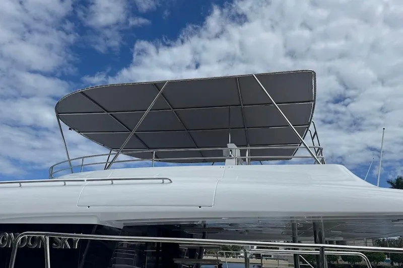 Slide: The Image of 2015 Lagoon yacht with canopy against a partly cloudy sky. - 7