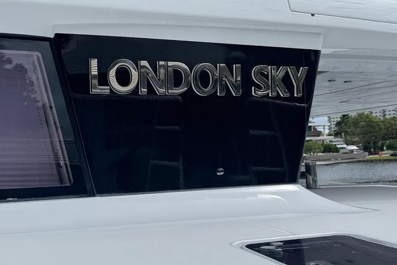 Slide: The Image of Lagoon 2015 yacht "London Sky" nameplate, docked with scenic background. - 8