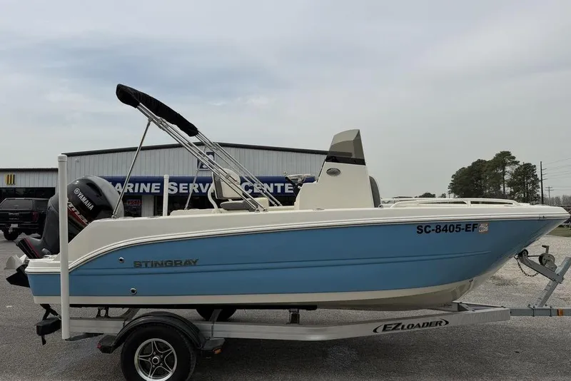 The Image of 2004 Robalo 1820 Center Console boat on trailer at marine service center. - 1