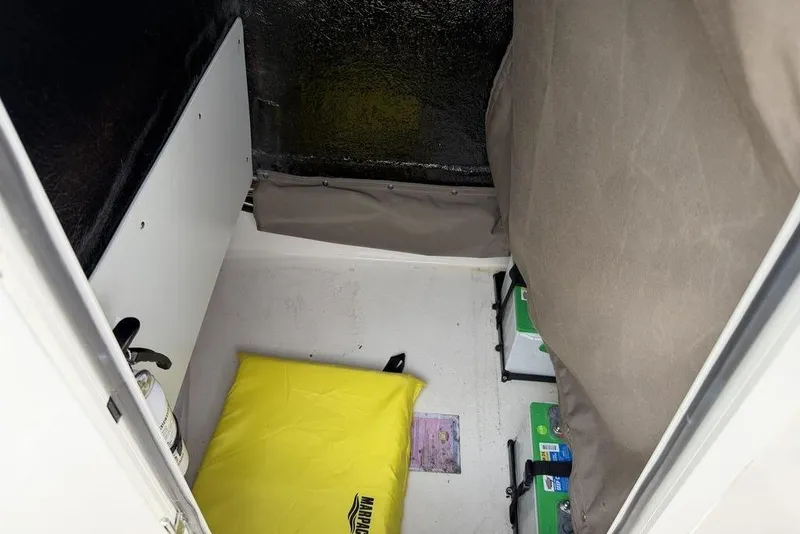 Slide: The Image of Interior of a 2004 Robalo 1820 Center Console boat with storage and equipment. - 12