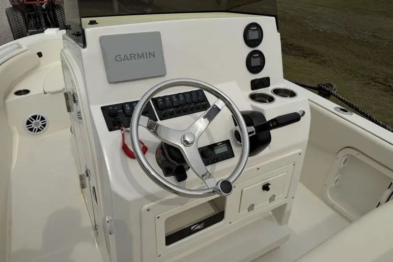 Slide: The Image of 2004 Robalo 1820 Center Console boat dashboard with Garmin navigation system. - 13