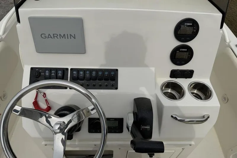 Slide: The Image of 2004 Robalo 1820 Center Console dashboard with Garmin display and Yamaha controls. - 17
