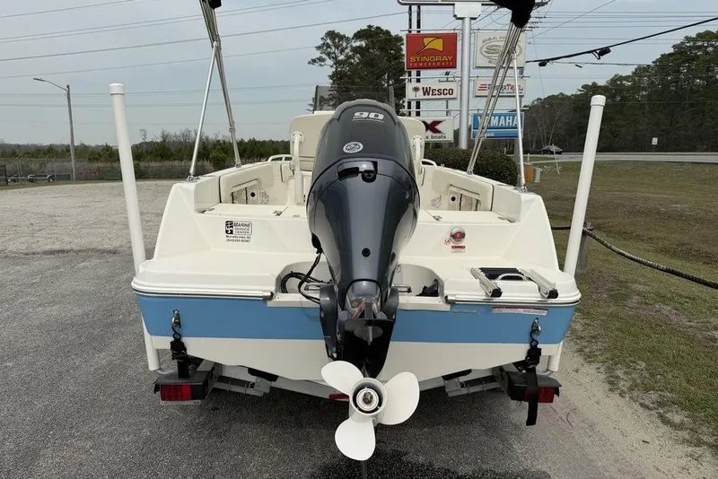 Slide: The Image of 2004 Robalo 1820 Center Console boat with Yamaha 90 outboard motor, parked outdoors. - 6