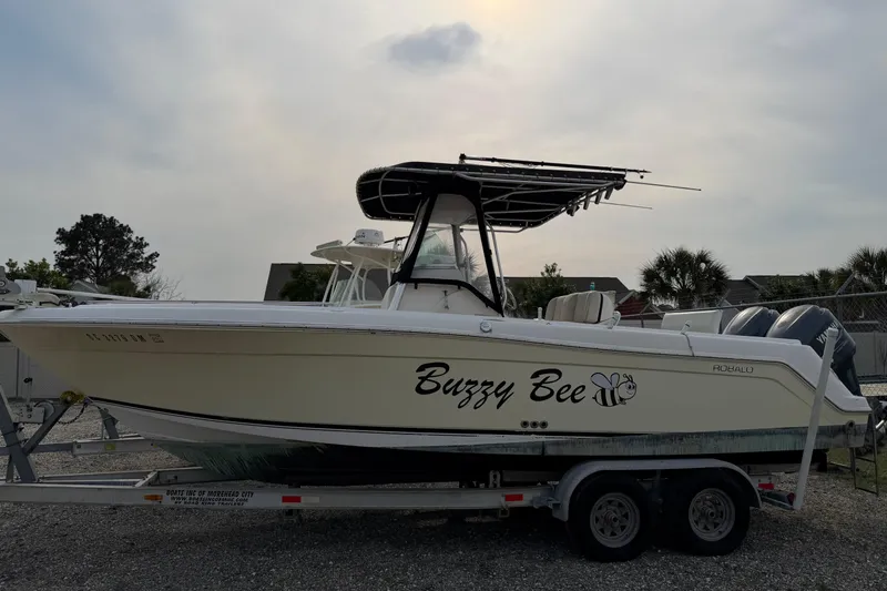 The Image of 2004 Robalo R260 Center Console boat named "Buzzy Bee" on a trailer. - 0